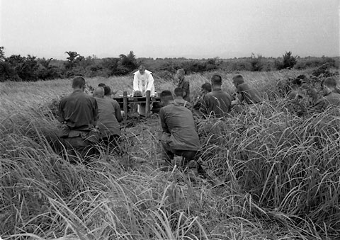 Catholic Chaplain celebrates mass for troops of Bn. Landing Team 1/26 at the Bn. Command Post during Operation Deck House IV near DMZ. 3rd Mar. Div., Quang Tri Province, Sept. 16, 1966. USMC Photo: Sgt. Cothran